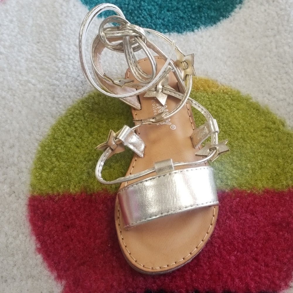 Little girls hold sandals